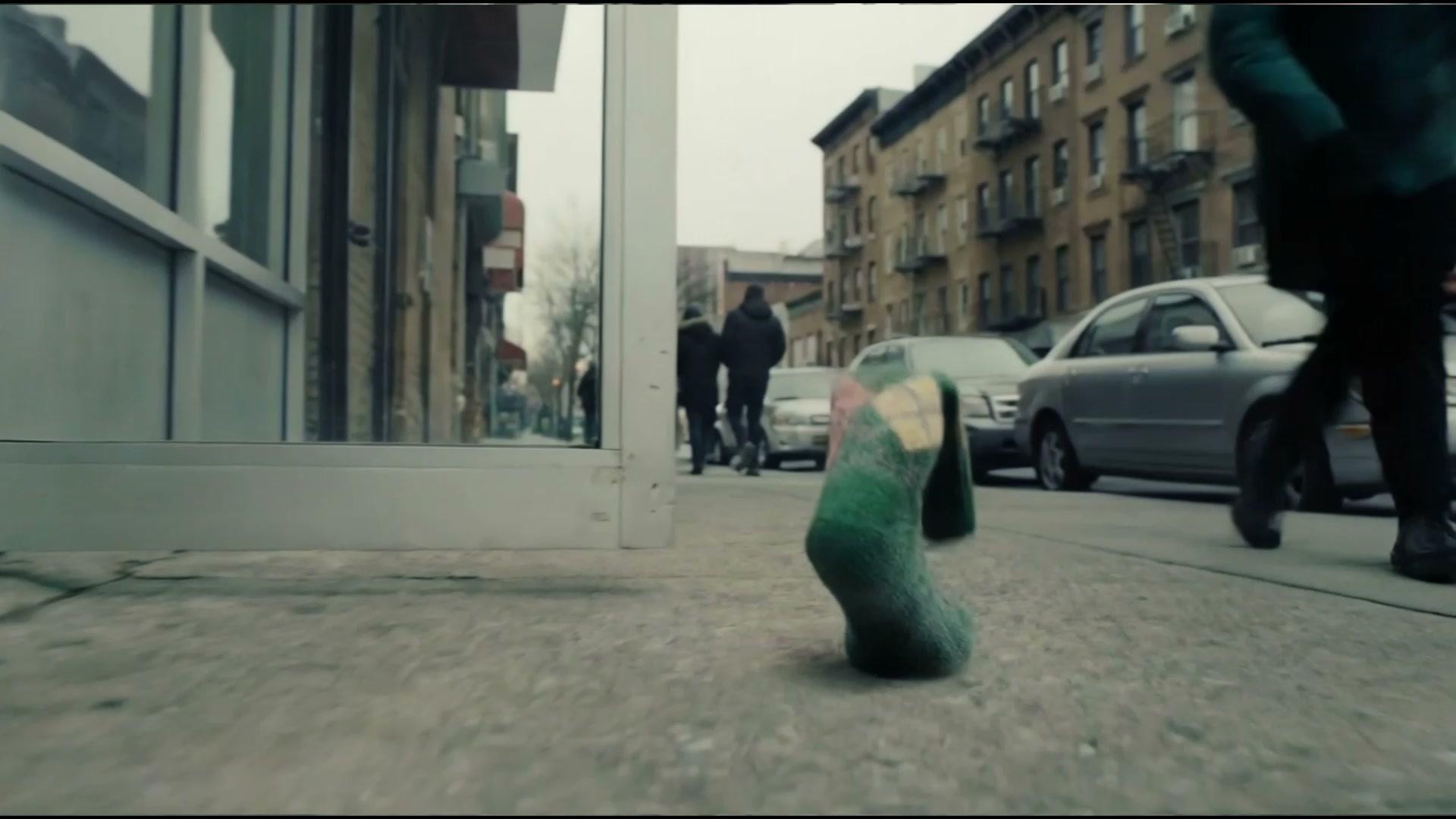 Corgi sniffing the curious green argyle sock